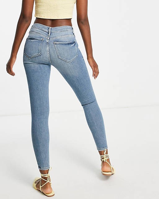 Mid Rise Ripped Knee Skinny Jeans In Medium Blue